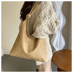 Vintage apricot PU tote bag with textured finish and knot shoulder strap detail