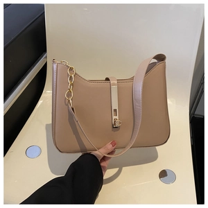 Close-up of beige hobo bag featuring golden metal chain strap and sleek buckle detail