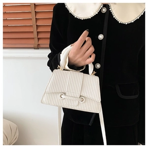 Minimalist white textured tote bag with vertical stripes and crossbody strap on model