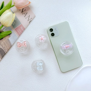 Cute resin phone grip set with 3D bow and candy designs on a mint smartphone case