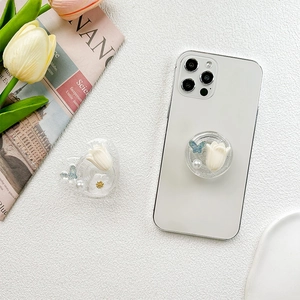 Support de téléphone avec tulipe pailletée et nœud sur un smartphone blanc