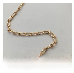 Close-up of high-quality polished gold metal chain strap with oval links for handbags