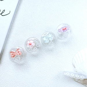 Detail of four colorful resin phone grips with bow and floral designs on white texture