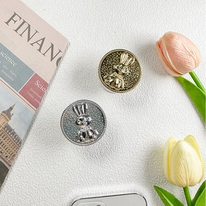 Detail of cute 3D bunny foldable phone grip sockets in gold and silver plating