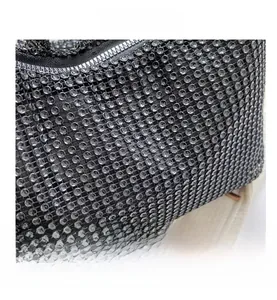 Macro view showing the detailed rhinestone pattern and high-quality zipper on the luxury bag