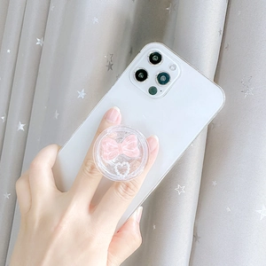 Cute pink bow and heart bead phone grip stand mounted on a white smartphone
