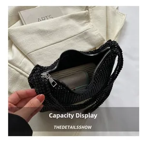 Internal view of black rhinestone shoulder bag showing spacious storage capacity