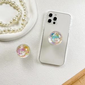 Close-up of a round glitter phone socket featuring a white rabbit and colorful star sequins