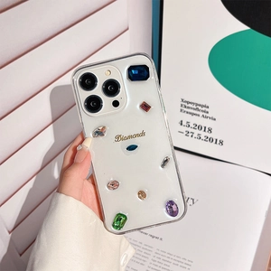 Detail of transparent phone case with colorful inlaid gems and gold Diamonds text
