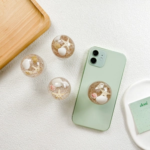 Expandable phone socket featuring crystal beach shell and starfish design on white background