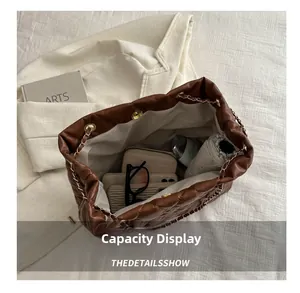 Top view of brown quilted bucket bag interior showing large capacity for daily items