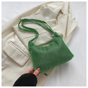 Close-up of a luxury green rhinestone hobo bag with sparkling crystals and silver zipper
