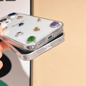 Detail view of iPhone case with multi-color rhinestones and Diamonds gold lettering