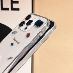 Close-up of transparent iPhone case with colorful rhinestones and gold Diamonds text