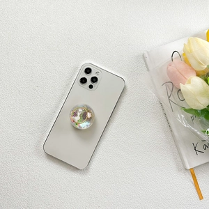Close-up of glitter rabbit resin phone socket grip on a white smartphone case