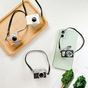 Macro shot of retro camera phone sockets with straps in black, orange, and white colors