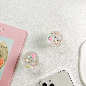 Detail of clear resin phone grips with pink strawberry and butterfly glitter sequins