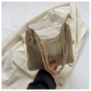 Fashionable gold rhinestone handbag with shimmering beads for elegant evening party wear