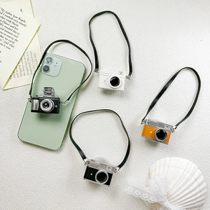 Detail of retro camera phone socket with long neck strap in multiple vintage colors