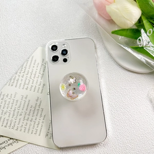 Detail view of a round crystal phone grip with pink butterflies and strawberry sequins