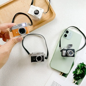 Collapsible vintage camera phone socket grip with decorative lanyard in four retro colors