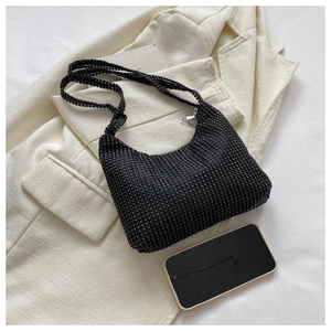 Macro detail of black rhinestone hobo bag with silver zipper and sparkling texture