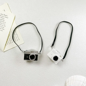 Detail of retro camera phone sockets in silver and white colors with lanyards