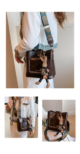 Detail of vintage brown bucket bag with ethnic strap and plush rabbit charm