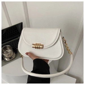 Detail of white saddle bag with golden metal lock and tubular shoulder strap with chain