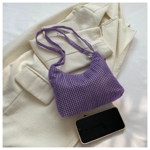 Top view of purple rhinestone baguette bag showing interior space with a smartphone