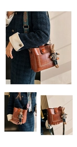 Detail of brown leather bucket bag with pearl trim, bunny charm and ethnic strap