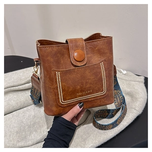 Brown PU leather bucket bag detail with ethnic printed strap and fashion text print
