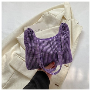 Close-up of purple rhinestone handbag showing sparkling crystal mesh and soft structure