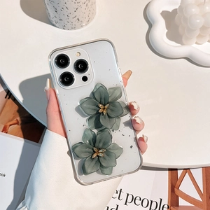 Close-up of clear iPhone case with 3D green flowers and silver foil glitter details