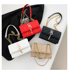Detailed overhead view of quilted leather chain bags with gold tassels in four colors