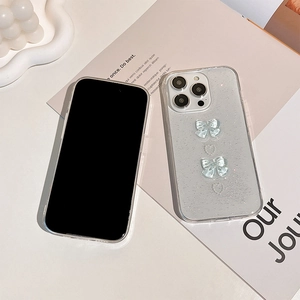 Close-up of glitter iPhone case with 3D light blue bows and mini heart decorations