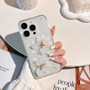 Detail of transparent iPhone case with 3D white resin flowers and silver foil flakes