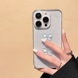 Detail of iPhone case with fine silver glitter and 3D light blue translucent bows