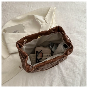 Internal view of brown quilted tote bag showing large capacity for essentials