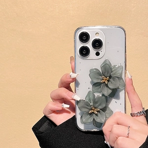 Detail of transparent iPhone case featuring 3D grey resin flowers and gold accents