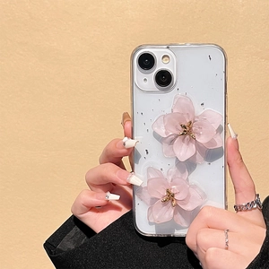 Detail of transparent iPhone case with 3D pink resin flowers and silver foil flakes