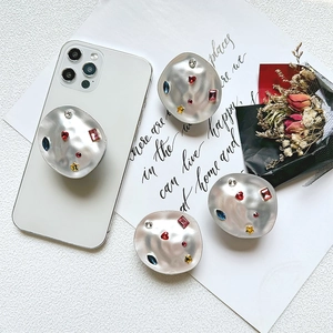 Luxurious metal phone socket grip with colorful rhinestones and irregular hammer texture
