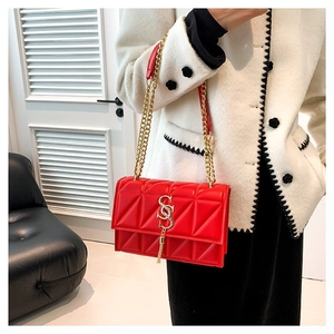 Red quilted leather shoulder bag with gold chain strap and stylish tassel detail