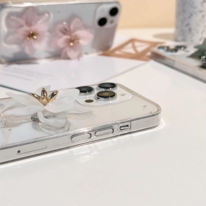 Macro detail of 3D floral decoration with golden stamens on transparent iPhone case