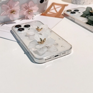 Detail of 3D floral iPhone case with silver foil accents and golden flower centers