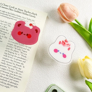 Close-up of cute acrylic bear and rabbit griptoks with dessert motifs on a desk