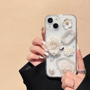 Detail of floral iPhone case with 3D relief flowers and pearl accents held by a hand