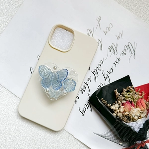 Detail of 3D rose and butterfly pearls inside a heart-shaped phone grip stand