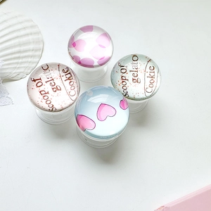 Detail of round glass phone sockets with pink hearts and gelato cookie art designs