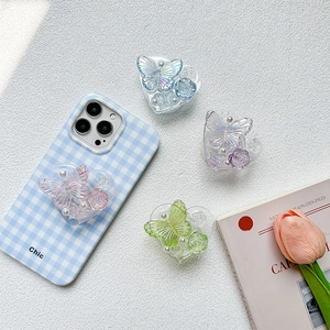 Detail of chic butterfly and rose pearl heart phone grips on a gingham phone case